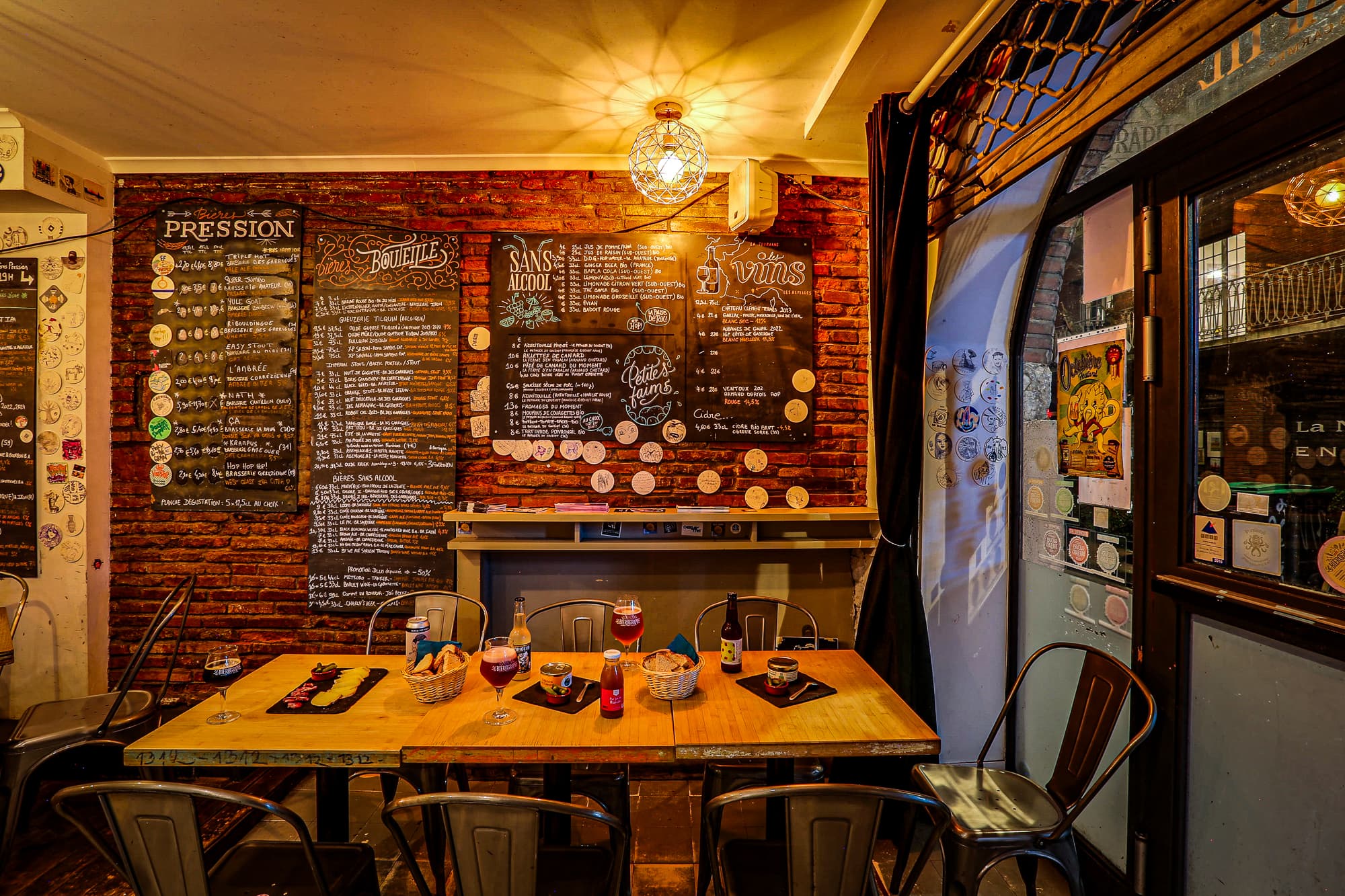 Wine and non-alcoholic drinks chalkboard menu above a set table
