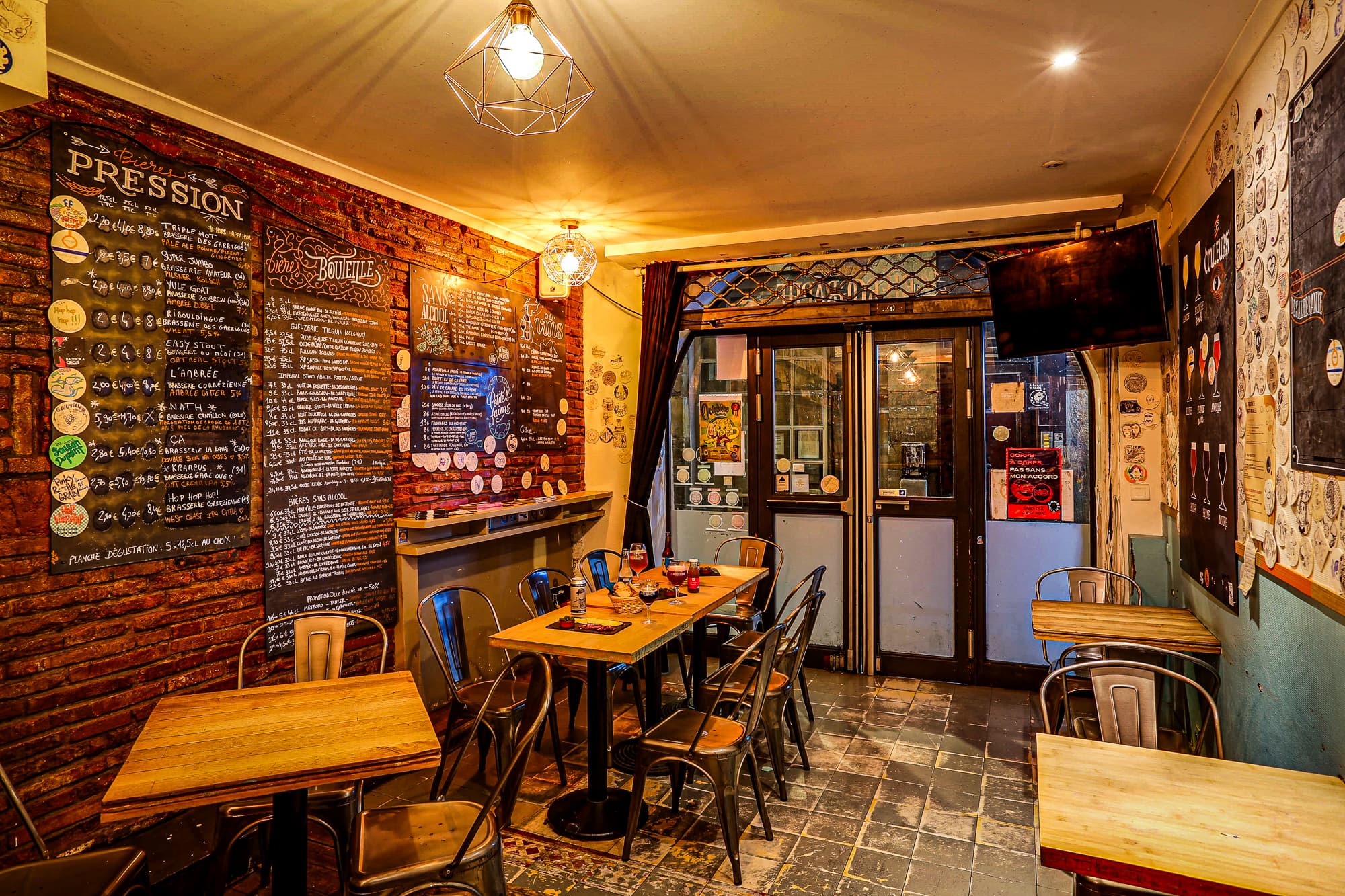 The upstairs bar counter and ceiling covered in tasting coasters