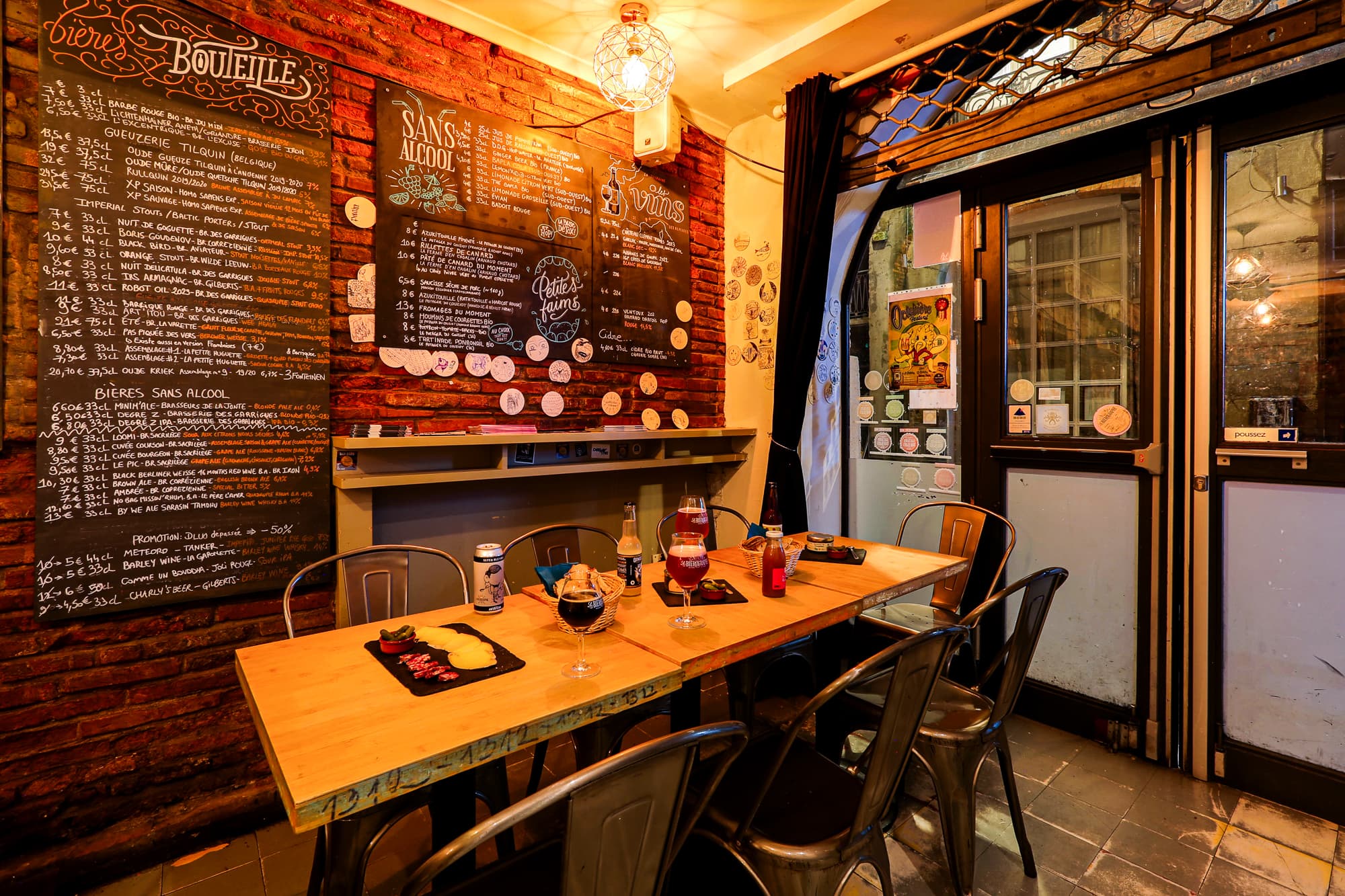A set table with charcuterie, wine, and the wine chalkboard menu
